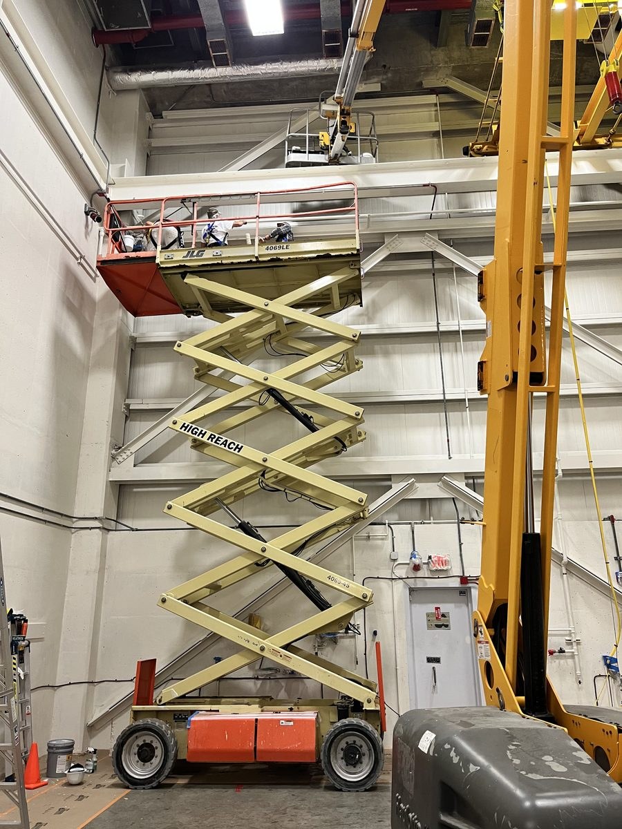 Industrial facility scissor lift painting